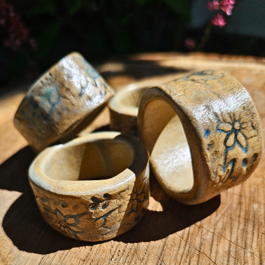Vier Serviettenringe aus Keramik mit floralem Design